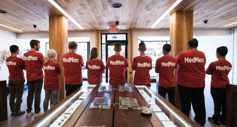 MedMen employees with the company name on the backs of their shirts