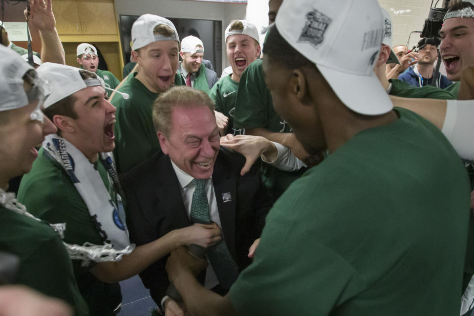 Michigan State head coach Tom Izzo, center, celebrates with his team after an NCAA men's East Regional final college basketball game against Duke in Washington, Sunday, March 31, 2019. Michigan State won 68-67. (AP Photo/Alex Brandon)