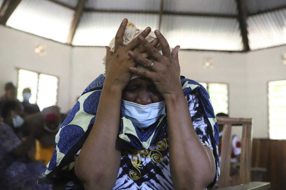 A family member grieves as she wait to receive the bodies of victims of a religious cult for burial in Malindi Funeral home in Kilifi, Kenya Tuesday, March. 26, 2024. Kenya government on Tuesday released seven bodies of victims, who died due to starvation to their families for burial. Some 34 bodies, out of the 429 that were exhumed last year, were positively identified. (AP Photo/Andrew Kasuku)