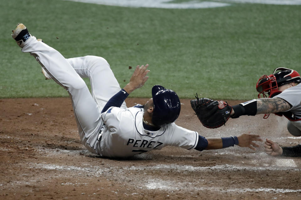 Tampa Bay Rays' Michael Perez, left, scores ahead of the tag by Boston Red Sox catcher Christian Vazquez on an RBI triple by Austin Meadows during the fifth inning of a baseball game Tuesday, Aug. 4, 2020, in St. Petersburg, Fla. (AP Photo/Chris O'Meara)