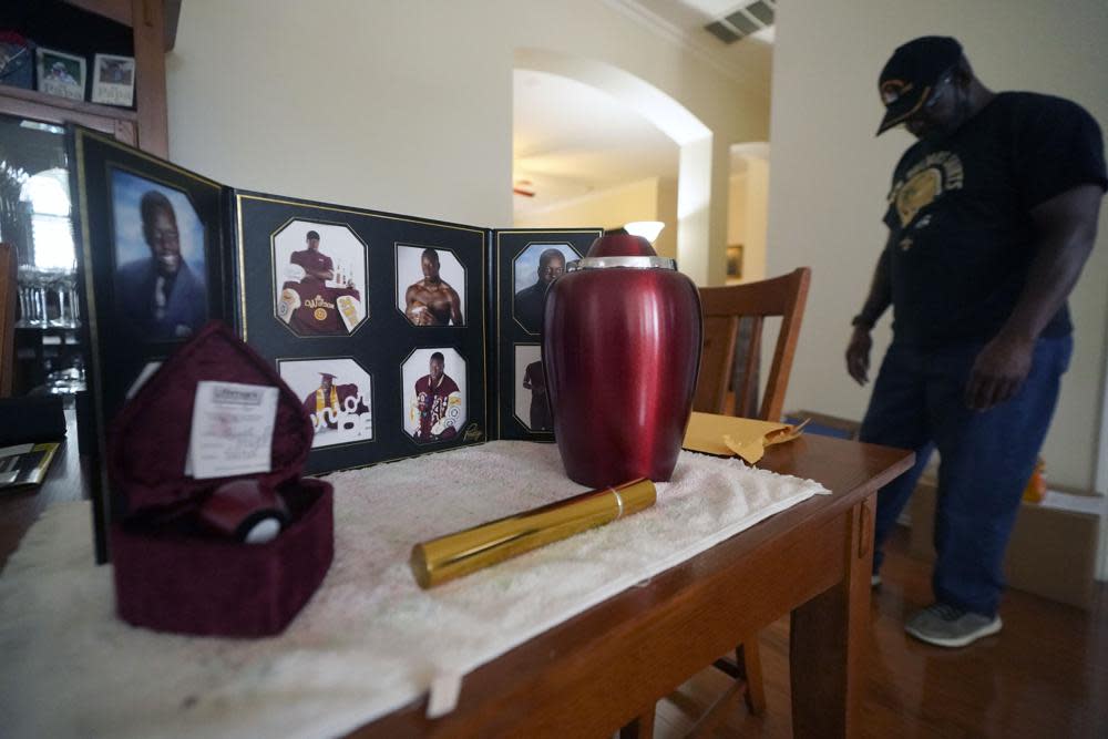 Former U.S. Marine and retired law enforcement officer Marvin Wilson pauses next to an urn holding the ashes of his son along with photos of Tyrell Wilson in Fort Worth, Texas, Monday, May 17, 2021. (AP Photo/LM Otero)