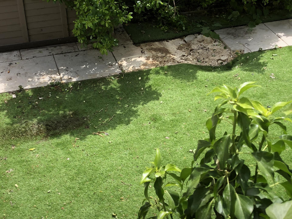 The force of the body landing caused a small crater in the back garden (Picture: SWNS)