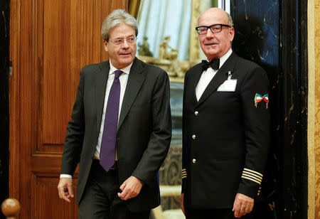 Italian Prime Minister-designate Paolo Gentiloni (L) leaves at the end of a meeting at the Low Chamber in Rome, Italy December 12, 2016. REUTERS/Remo Casilli