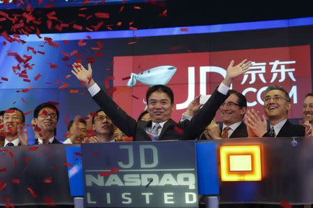 Richard Liu, CEO and founder of China's e-commerce company JD.com, raises his hands after the opening bell at the NASDAQ Market Site building at Times Square in New York May 22, 2014. REUTERS/Shannon Stapleton