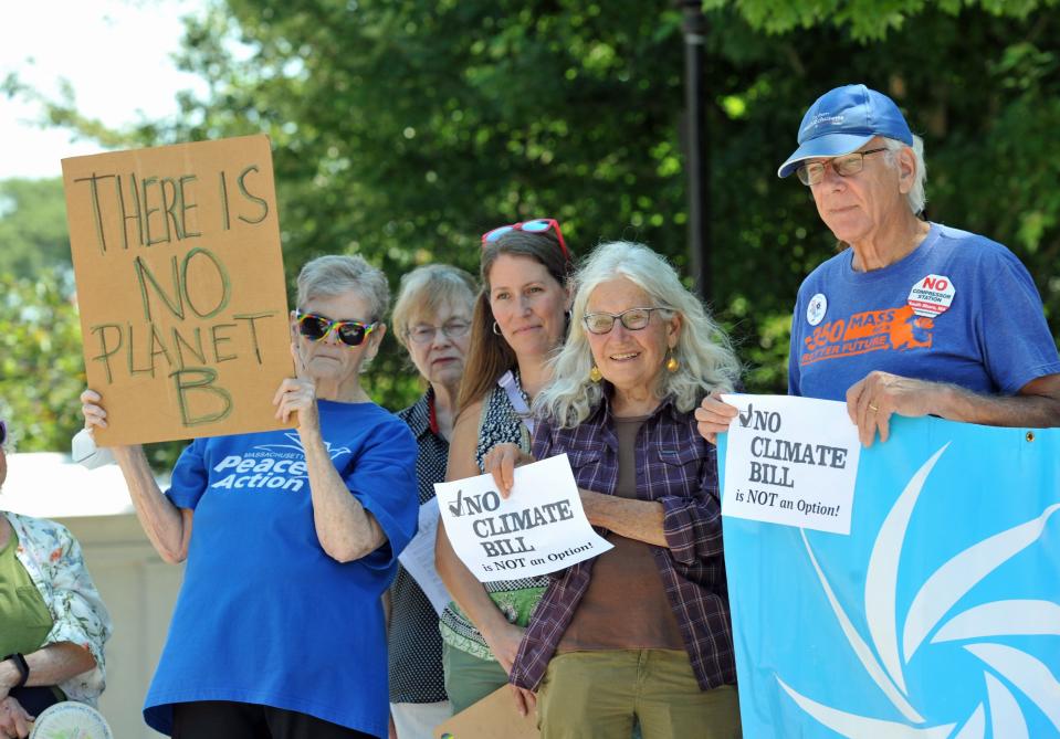 Members of the Mass Power Forward rally in front of Quincy City Hall supporting legislation that would address climate change, Monday, July 11, 2022.