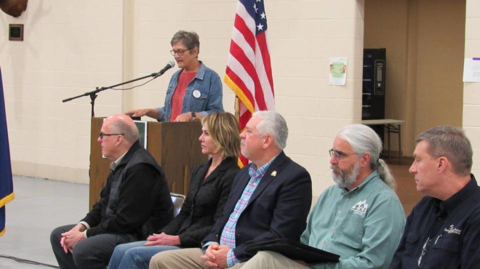 Gerry Roll, at the podium, head of the Foundation for Appalachian Kentucky, announces donations for housing in Knott County on April 11, 2023. Seated from left are Joe and Kelly Craft, who donated $4 million for the project; state Rep. John Blanton, R-Salyersville; Scott McReynolds, head of the Housing Development Alliance; and Luther Harrison from Samaritan’s Purse.
