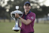 Carlos Ortiz holds the champion's trophy after winning the Houston Open golf tournament, Sunday, Nov. 8, 2020, in Houston. (AP Photo/Eric Christian Smith)