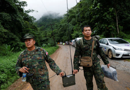 Soldiers carry a radio near Tham Luang cave complex during a search for members of an under-16 soccer team and their coach, in the northern province of Chiang Rai, Thailand, June 28, 2018. REUTERS/Soe Zeya Tun