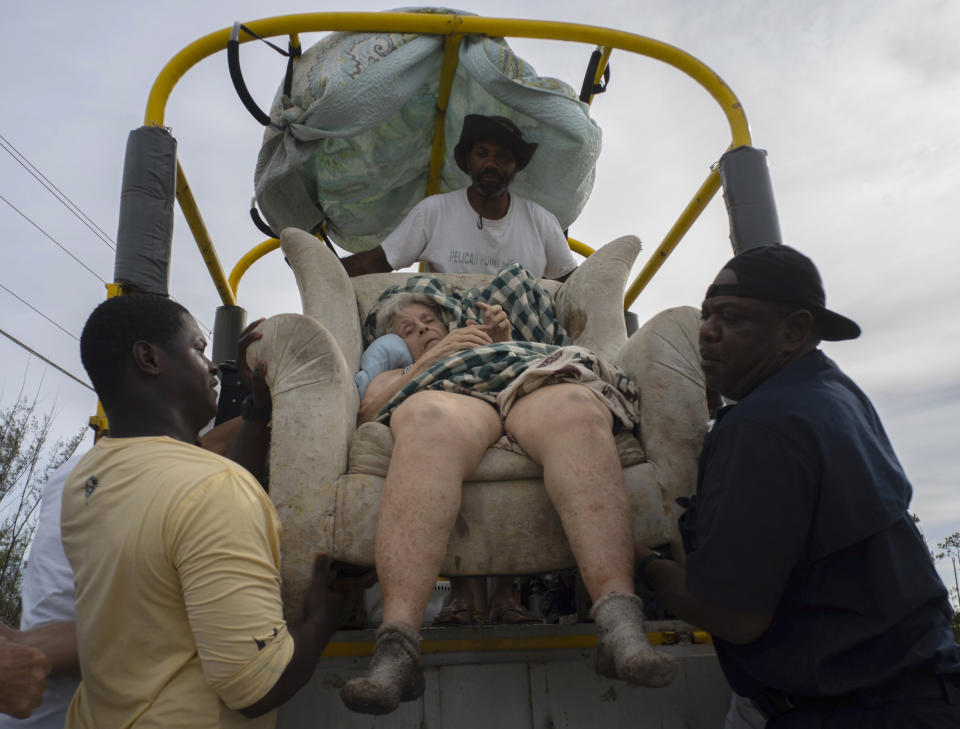 Sitting in her home's lounger, Virginia Mosvold, 84, is lowered from a truck by volunteers after being rescued from her flooded home on Ol' Freetown Farm farm in the aftermath of Hurricane Dorian before being taken to the hospital on the outskirts of Freeport, Bahamas, Wednesday, Sept. 4, 2019. Rescue crews in the Bahamas fanned out across a blasted landscape of smashed and flooded homes trying to reach drenched and stunned victims of Hurricane Dorian and take the full measure of the disaster. (AP Photo/Ramon Espinosa)