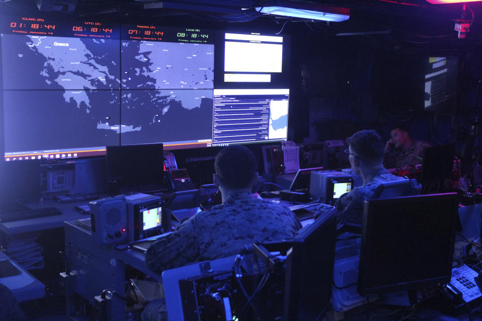 U.S. Marines on watch stander duty monitor screens at the Land Force Operation Center Unit on the USS Bataan in the Aegean Sea, Greece, Friday, Jan. 19, 2024. The Bataan, an amphibious assault ship, is leading a U.S. Navy task force in the eastern Mediterranean as the United States maintains an increased level of military deployment in the Middle East. (AP Photo/Derek Gatopoulos)