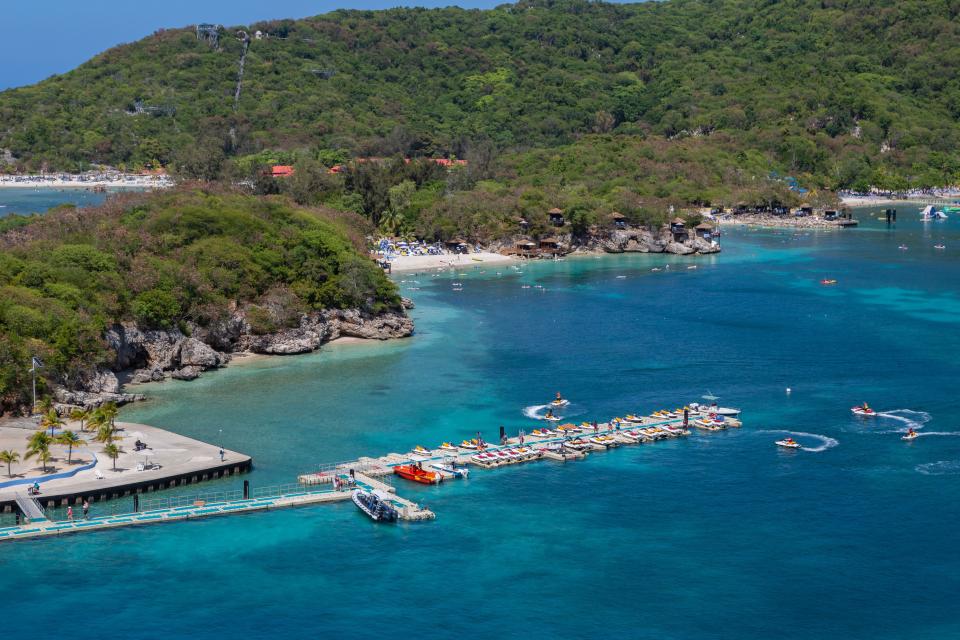 Cruise ship passengers playing on jet skis near the pier on Royal Caribbean's private coastal peninsula of Labadee, Haiti.