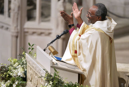 FILE PHOTO: The Reverend Michael Bruce Curry applauds as he begins his sermon after his Installation ceremony, at the Washington National Cathedral, in Washington, November 1, 2015. Curry becomes the first African-American Episcopal presiding bishop, after previously serving as Bishop of North Carolina. REUTERS/Mike Theiler/File Photo