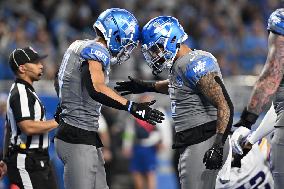 Jan 7, 2024; Detroit, Michigan, USA; Detroit Lions running back David Montgomery (5) celebrates with wide receiver Amon-Ra St. Brown (14) after scoring a touchdown against the Minnesota Vikings in the third quarter at Ford Field. Mandatory Credit: Lon Horwedel-USA TODAY Sports