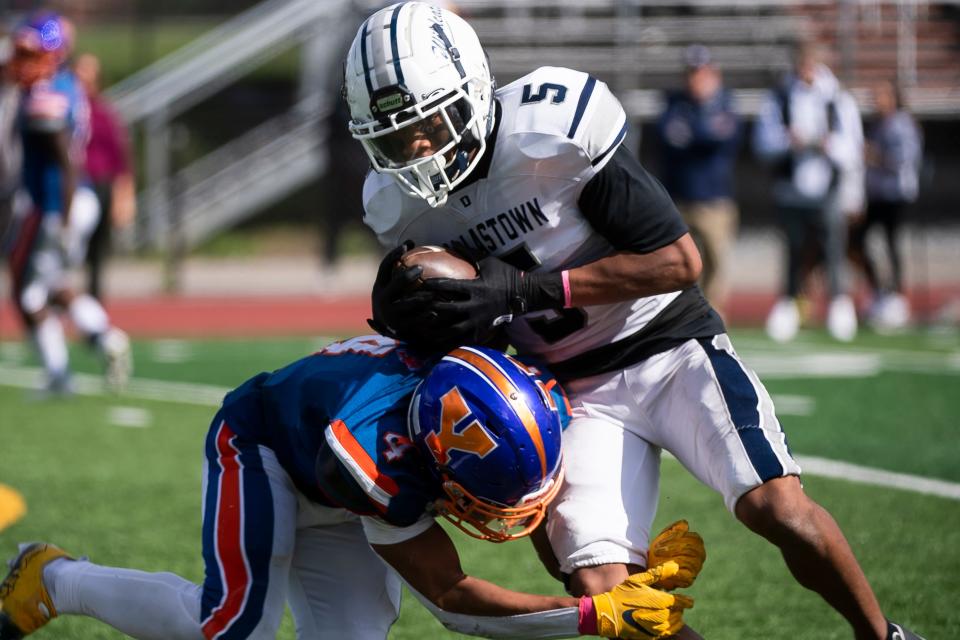 York High's Jahiem White (4) makes the tackle on Dallastown's Kenny Johnson during a YAIAA Division I football game. Both White and Johnson were named to the Class 6A all-state football team.
