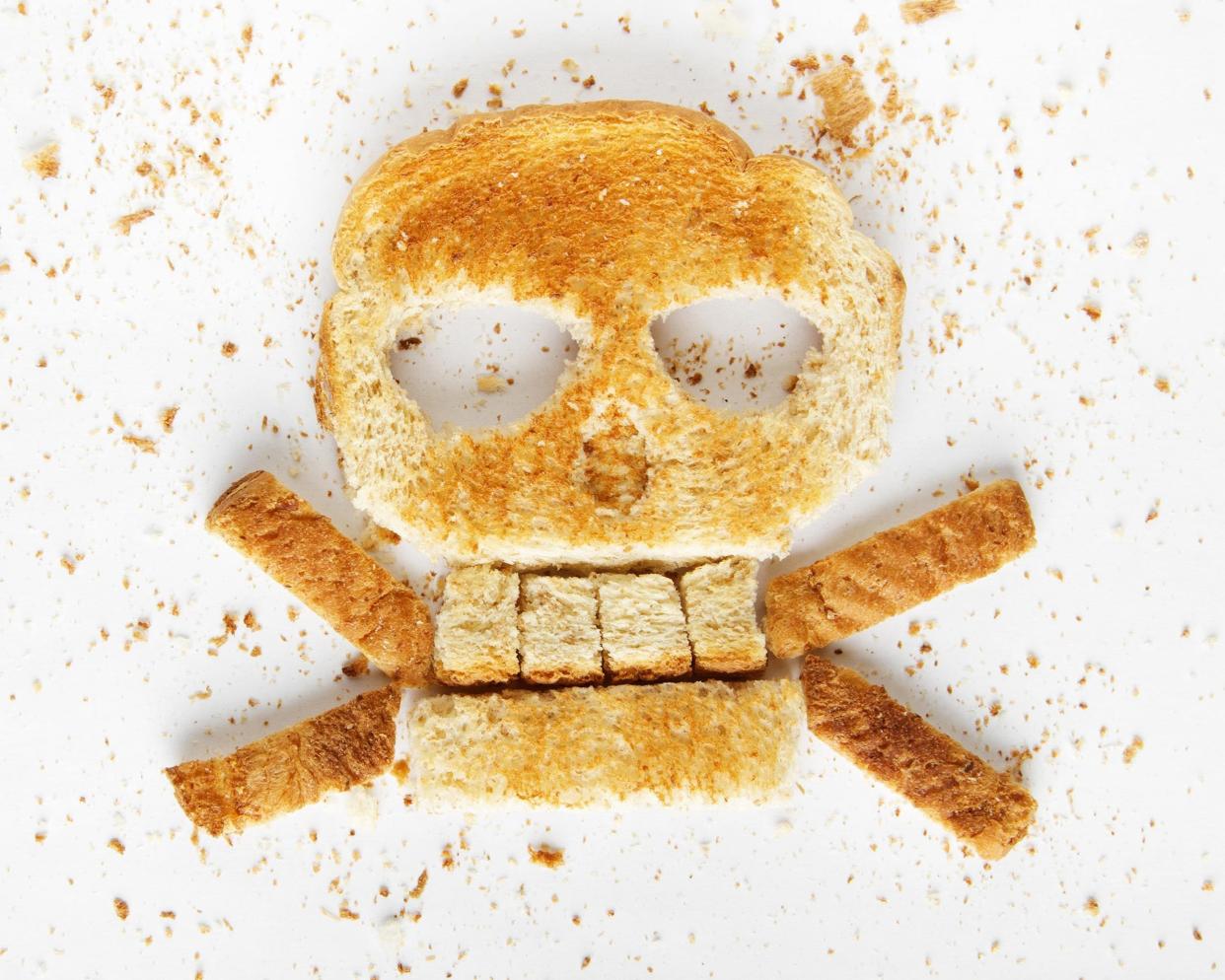 bread skull and crossbones with crumbs on white background