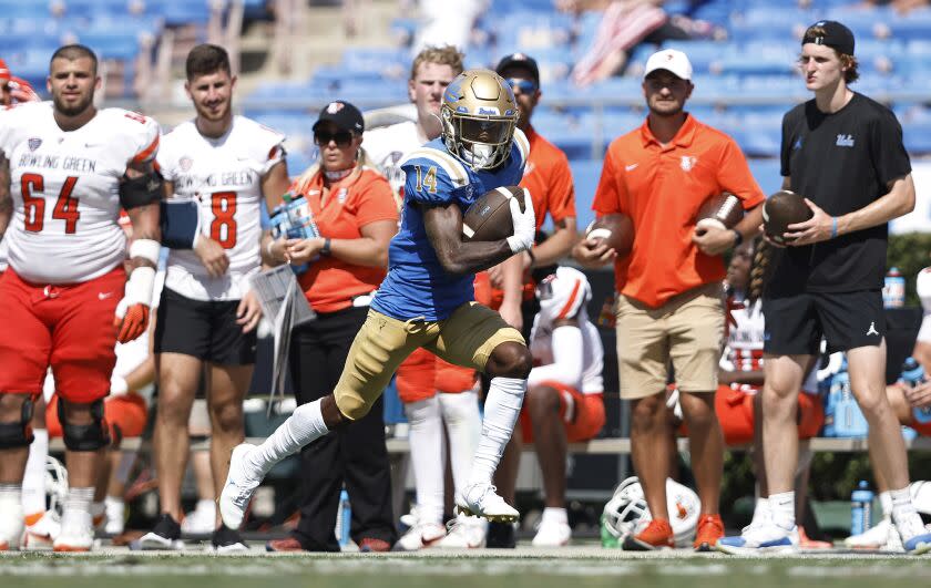 PASADENA, CALIFORNIA - SEPTEMBER 03: Josiah Norwood #14 of the UCLA Bruins celebrates.