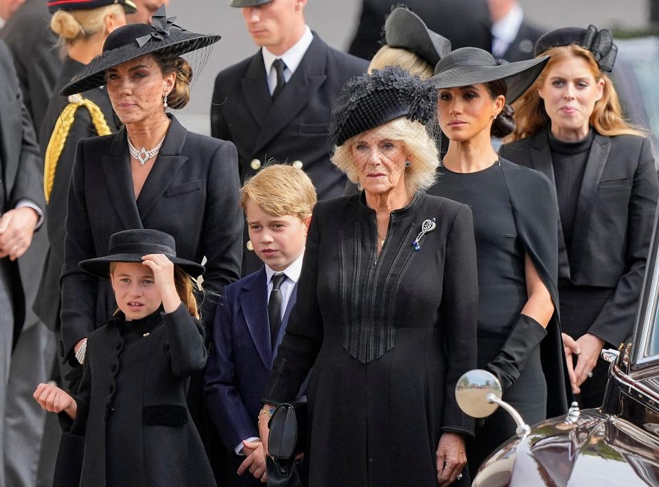 From left, Kate, Princess of Wales; Princess Charlotte; Prince George; Camilla, the Queen Consort; Meghan, Duchess of Sussex; and Princess Beatrice follow the coffin of Queen Elizabeth II following her funeral at Westminster Abbey in London on Monday, Sept. 19, 2022.