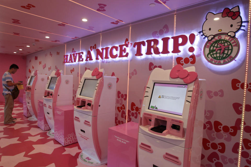 A passenger stands next to Eva Airlines' self check-in counters, which are decorated with Hello Kitty motifs, in Taoyuan International Airport, northern Taiwan, April 30, 2012. Taiwan's second-largest carrier, Eva Airlines, and Japan's comic company, Sanrio, which owns the Hello Kitty brand, collaborated on the second generation Hello Kitty-themed aircraft which was launched on October 2011. There are currently three Hello Kitty-themed Airbus A330-300 aircrafts flying between cities such as Taipei, Fukuoka, Narita, Sapporo, Incheon, Hong Kong and Guam. REUTERS/Pichi Chuang