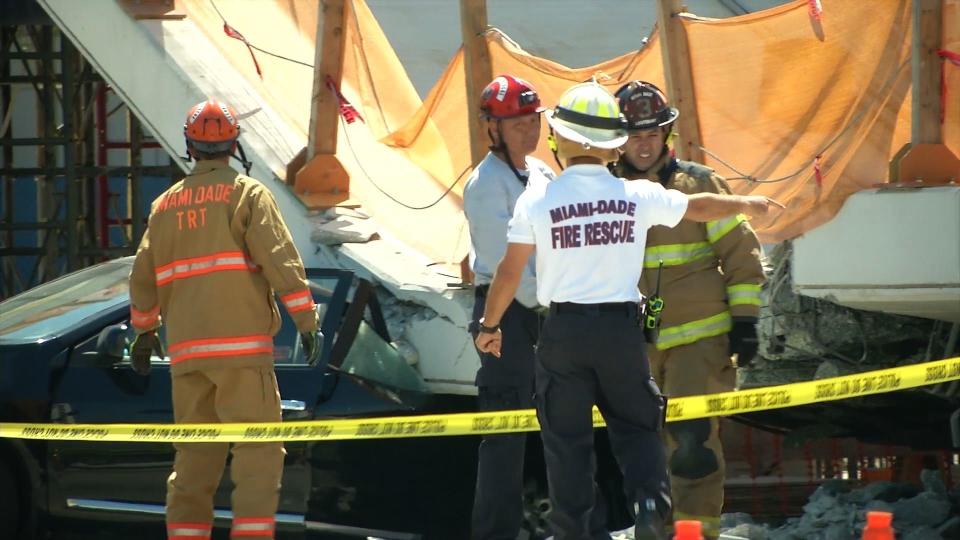 This AFP TV video frame grab shows emergency response workers at&nbsp;the collapsed pedestrian bridge.