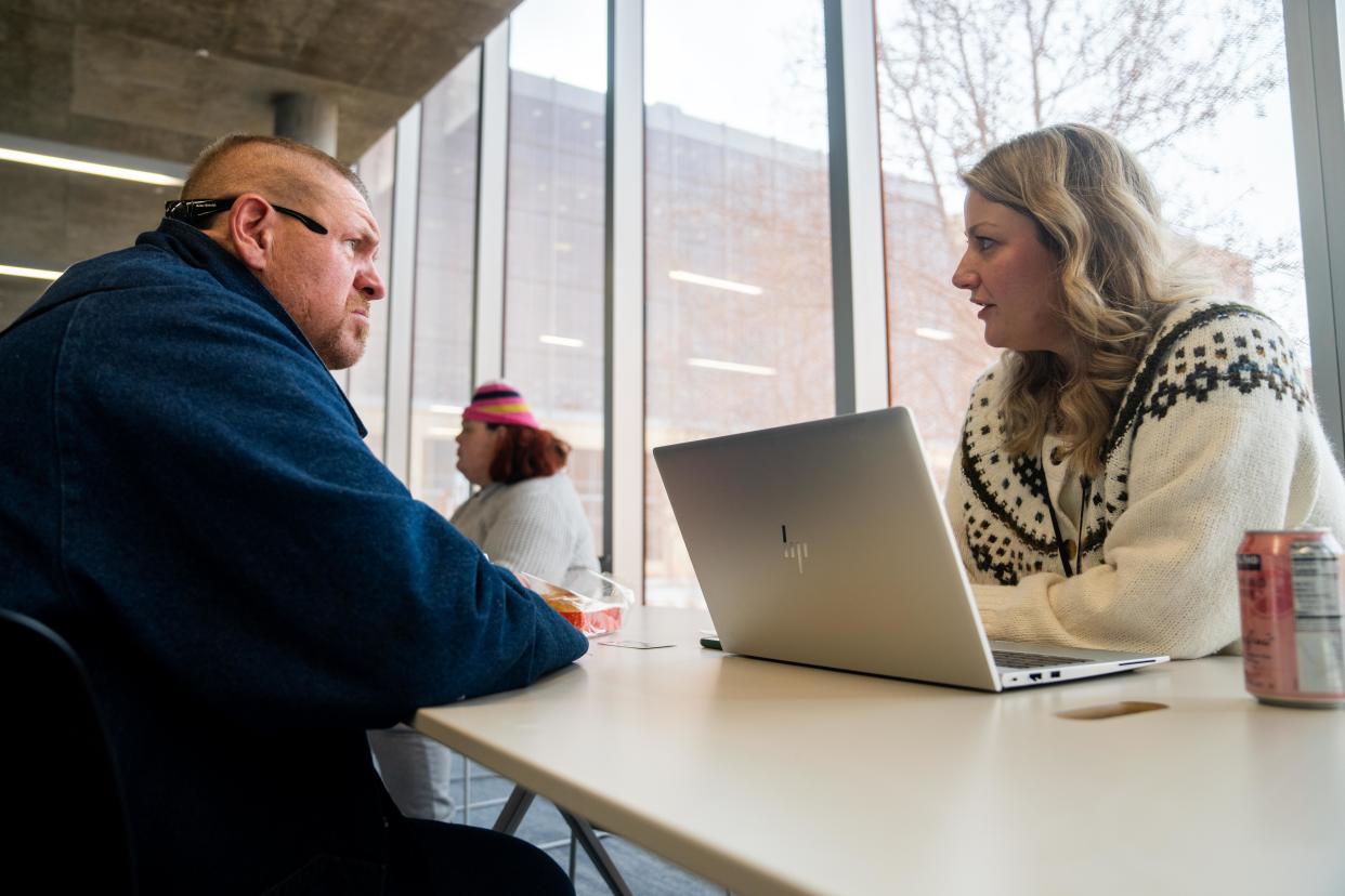 Ashlan Lippert talks with Buck Evans during the Monday session of the library's outreach program at Des Moines Central Library.