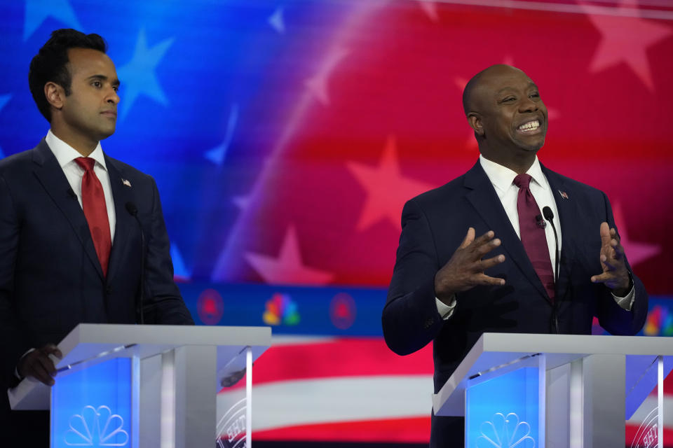 Republican presidential candidate Sen. Tim Scott, R-S.C., speaks as businessman Vivek Ramaswamy listens during a Republican presidential primary debate hosted by NBC News, Wednesday, Nov. 8, 2023, at the Adrienne Arsht Center for the Performing Arts of Miami-Dade County in Miami. (AP Photo/Rebecca Blackwell)