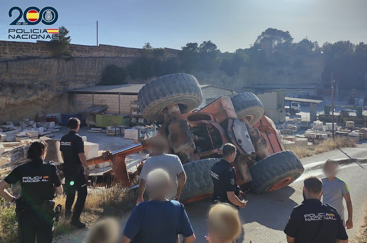 Police investigate the overturned excavator  (Policia Nacional)