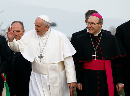 Pope Francis waves to the faithful, accompanied by Archbishop of Benevento Felice Accrocca, as he arrives in Pietrelcina, Italy, March 17, 2018. REUTERS/Ciro De Luca