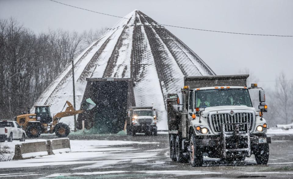 Salt trucks are loaded on Friday, Jan. 28, 2022, near the intersection of Washington St. and Tibbs Ave.  in Indianapolis. 