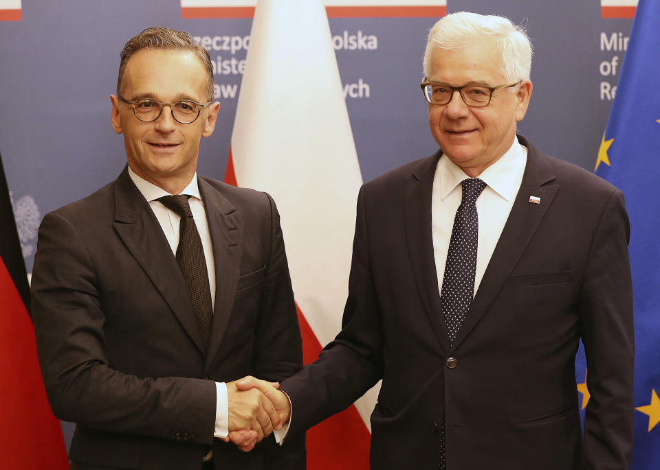 Poland's Foreign Minister Jacek Czaputowicz, right, greets his German counterpart Heiko Maas on a two-day visit to Poland for political talks and for the Sept. 1 anniversary observances of World War II Warsaw Rising of 1944, in Warsaw, Poland, Wednesday, July 31, 2019. (AP Photo/Czarek Sokolowski)