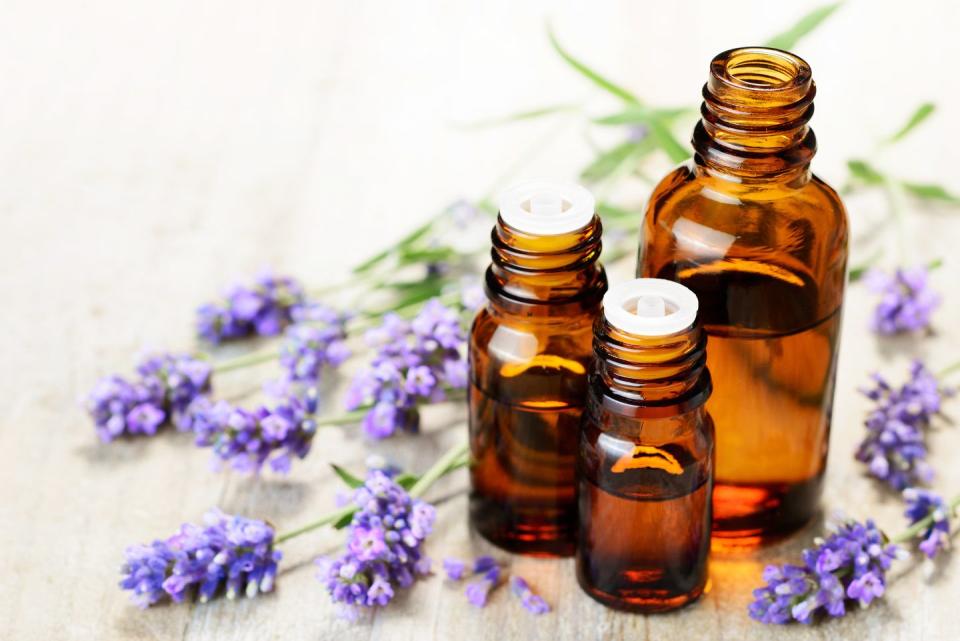 lavender essential oil in the amber bottle, with fresh lavender flower heads