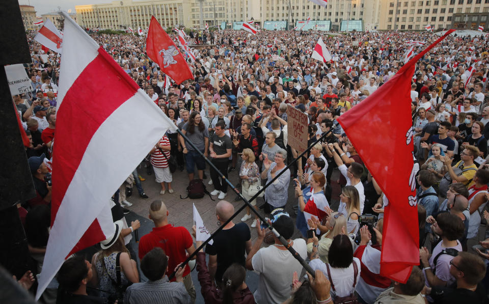 Belarusian opposition supporters gather for a protest rally in front of the government building at Independent Square in Minsk, Belarus, Tuesday, Aug. 18, 2020. Workers at more state-controlled companies and factories took part in the strike that began the day before and has encompassed several truck and tractor factories, a huge potash factory that accounts for a fifth of the world's potash fertilizer output and is the nation's top cash earner, state television and the country's most prominent theater. (AP Photo/Dmitri Lovetsky)