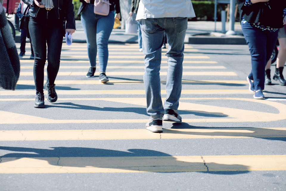 people walk on the sidewalk during the day