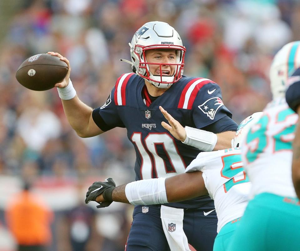 Patriots quarterback Mac Jones prepares to throw downfield during the regular-season opener against the Miami Dolphins on Sept. 12 in Foxboro. The Pats lost, 17-16.