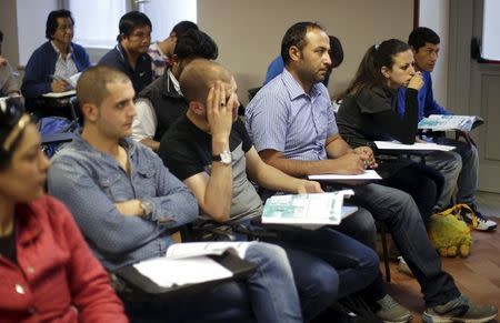 Syrian couple Hassan Zaheda (3rd R), 31, and Nour Essa (2nd R), 30, attend a lesson of Italian grammar following an interview with Reuters at Sant'Egidio community in Rome, Italy, April 20, 2016. REUTERS/Max Rossi