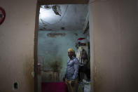 Emilio Roman who has his three children in prison accused of participating in the recent protests against the government, poses for a photo in the room of two of his children, at their home in the La Guinera neighborhood of Havana, Cuba, Wednesday, Jan. 19, 2022. Six months after surprising protests against the Cuban government, more than 50 protesters who have been charged with sedition are headed to trial and could face sentences of up to 30 years in prison. (AP Photo/Ramon Espinosa)