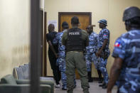 Alleged gang leader Arnel Joseph is taken back in handcuffs to the National Penitentiary after being brought before a judge for the first time since his July 2019 arrest in Port-au-Prince, Haiti, Monday, Jan. 25, 2021. Some 11,000 inmates are being held in prisons across Haiti, including the National Penitentiary, which was built for 800 prisoners but holds an estimated 3,800. (AP Photo/Dieu Nalio Chery)