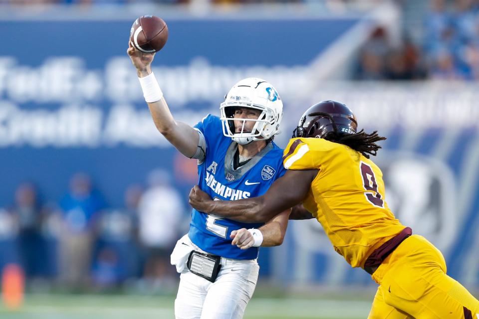 Memphis' Seth Henigan (2) throws the ball as Bethune-Cookman’s Eddie Walls III (9) tries to tackle him during the game between the University of Memphis and Bethune-Cookman University in Memphis, Tenn., on Saturday, September 2, 2023.