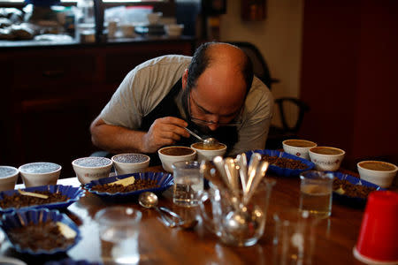 Luis Rodriguez tastes roasted coffee at El Borbollon coffee mill in Santa Ana, El Salvador on May 25, 2018. Picture taken on May 25, 2018. REUTERS/Jose Cabezas