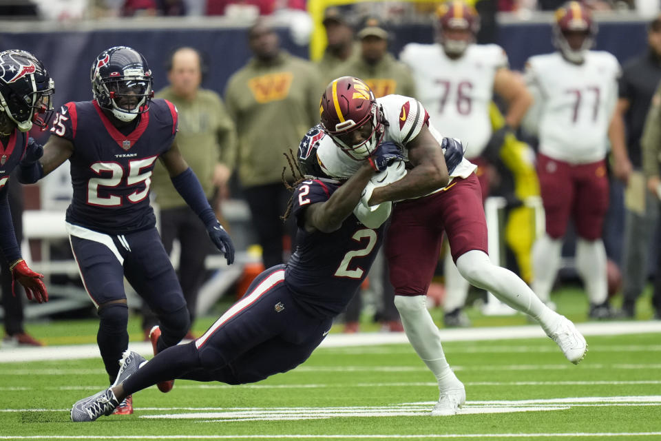 Washington Commanders wide receiver Curtis Samuel (10) is hit by Houston Texans cornerback Tavierre Thomas (2) on a run during the first half of an NFL football game Sunday, Nov. 20, 2022, in Houston. (AP Photo/Eric Christian Smith)