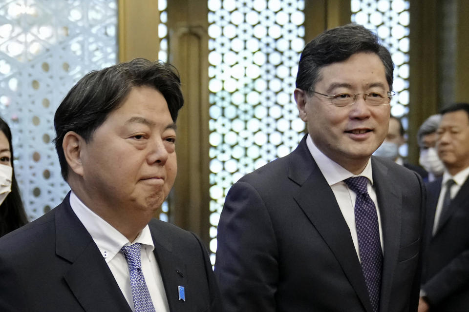 Japanese Foreign Minister Yoshimasa Hayashi, left, meets with his counterpart Qin Gang at the Diaoyutai State Guest House in Beijing Sunday, April 2, 2023. (Kyodo News via AP)