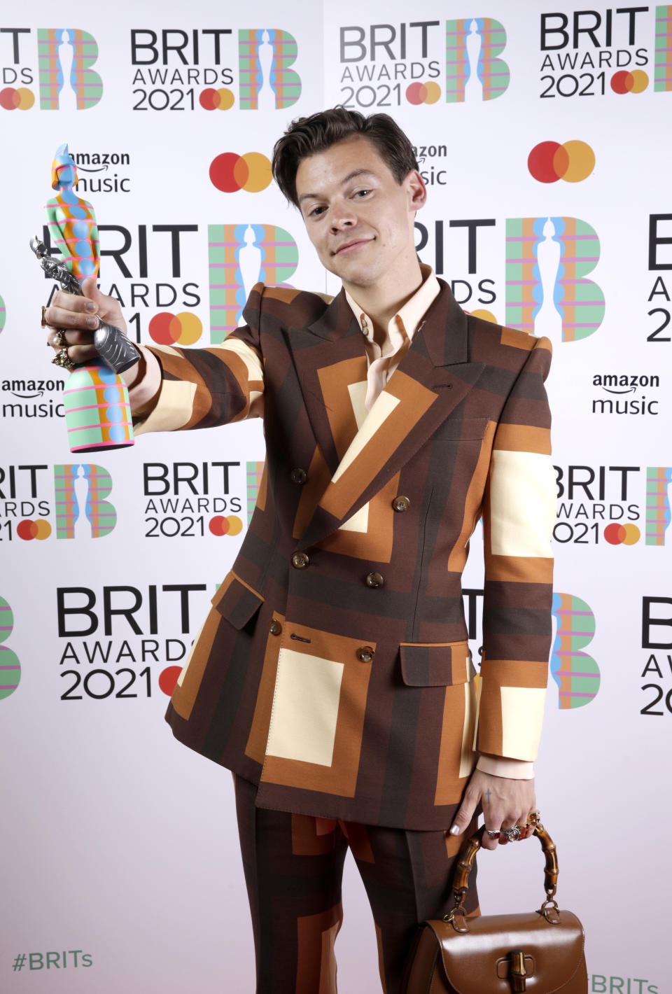 Harry Styles displays his award at The BRIT Awards in 2021