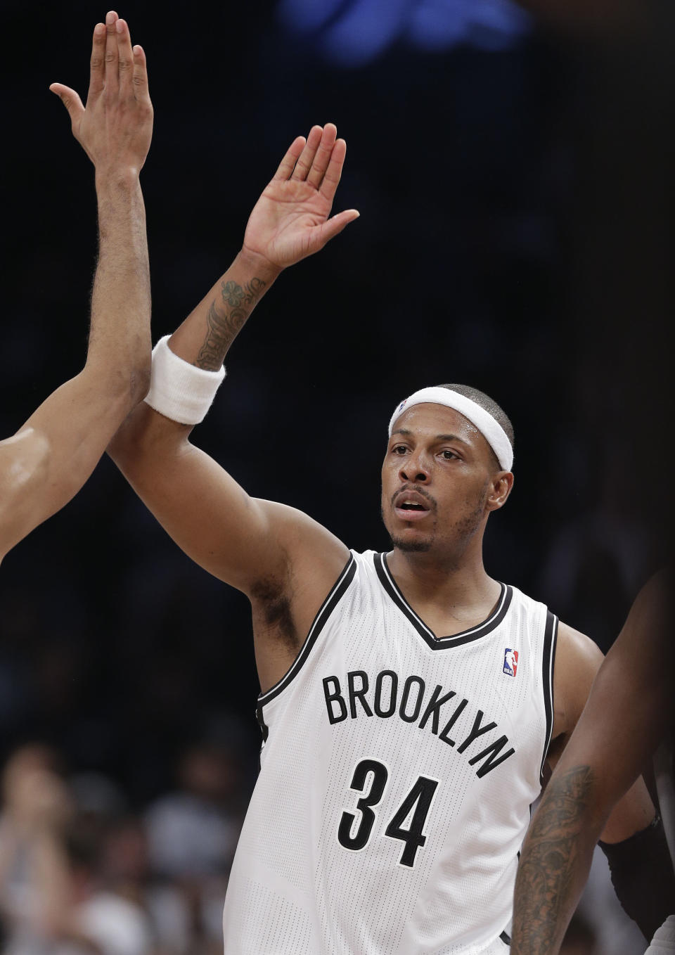 Brooklyn Nets forward Paul Pierce (34) celebrates with teammates after scoring against the Miami Heat in the fourth quarter during Game 3 of an Eastern Conference semifinal NBA playoff basketball game on Saturday, May 10, 2014, in New York. The Nets won 104-90. (AP Photo/Julie Jacobson)