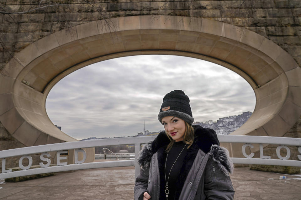 In this Monday, Feb. 8, 2021, photo, Allissa Star poses for a photograph along the north shore of the Allegheny River in Pittsburgh. Starr worked about a week every month at a brothel in Pahrump, Nev., outside of Las Vegas. Then the pandemic led to the shuttering of Nevada's licensed bordellos, the only place where prostitution is legal in the state, and they have remained closed since March, leaving sex workers like Starr struggling to pay the bills and turning to alternatives like "virtual" dates. (AP Photo/Keith Srakocic)