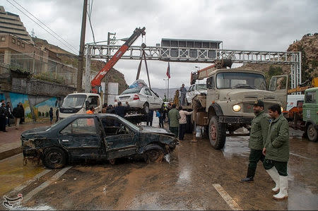 Damaged vehicles are seen after a flash flooding In Shiraz, Iran, March 25, 2019. Tasnim News Agency/Handout via REUTERS ATTENTION EDITORS - THIS IMAGE WAS PROVIDED BY A THIRD PARTY. NO RESALES. NO ARCHIVES