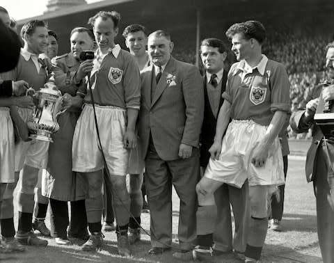 Peter Dimmock of the BBC interviews the winning captain, Harry Johnston, watched by the Blackpool manager Joe Smith, and, far right, Cyril Robinson - Credit: &nbsp;Colorsport/REX