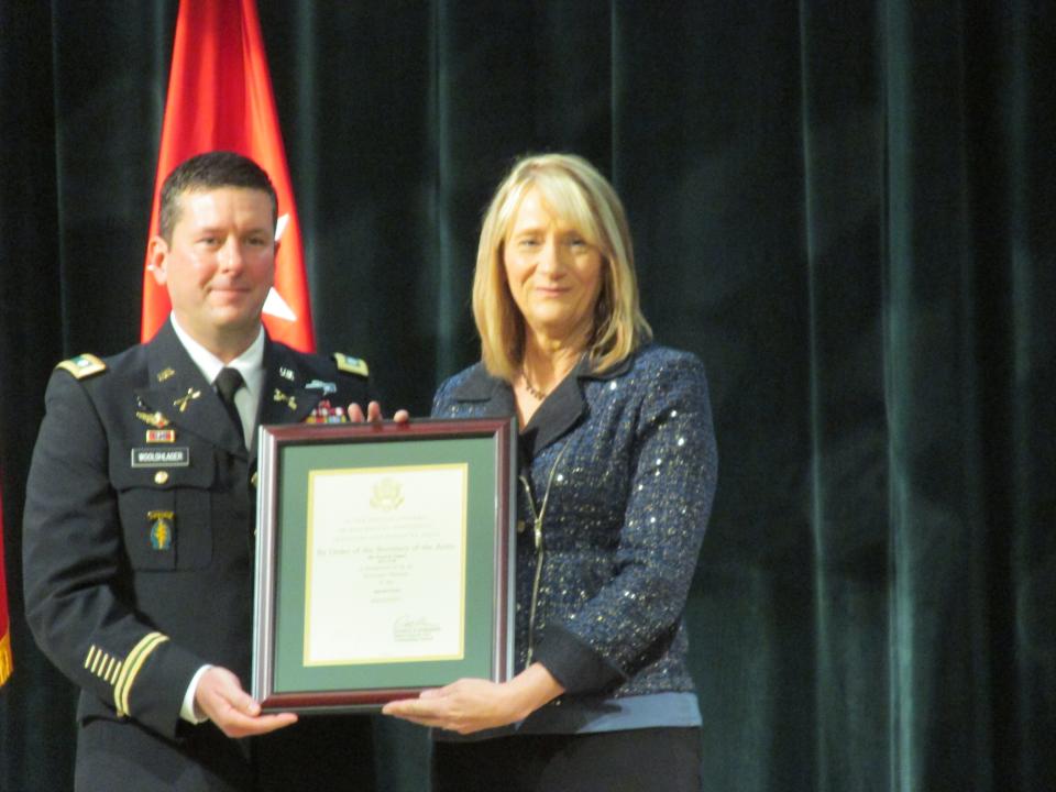 Teresa Nugent is welcomed by Lt. Col. Richard Woolshalger as an honorary member of the special forces regiment during a Nov. 4, 2021, ceremony at Fort Bragg.