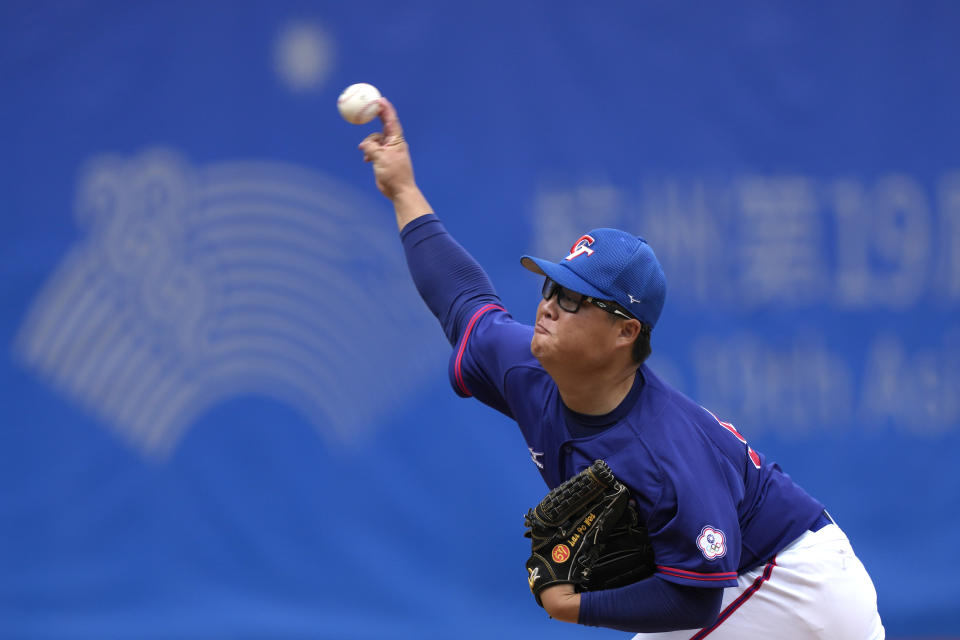 Taiwan's pitcher Lai Po-Wei throws the ball during stage group round B Baseball Men game against Hong Kong for the 19th Asian Games in Hangzhou, China on Tuesday, Oct. 3, 2023. At the Asian Games China has been going out of its way to be welcoming to the Taiwanese athletes, as it pursues a two-pronged strategy with the goal of taking over the island, which involves both wooing its people while threatening it militarily. (AP Photo/Ng Han Guan)