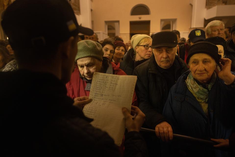 People wait for their names to be called from a list to board an evacuation train in Kherson, Ukraine (Getty Images)