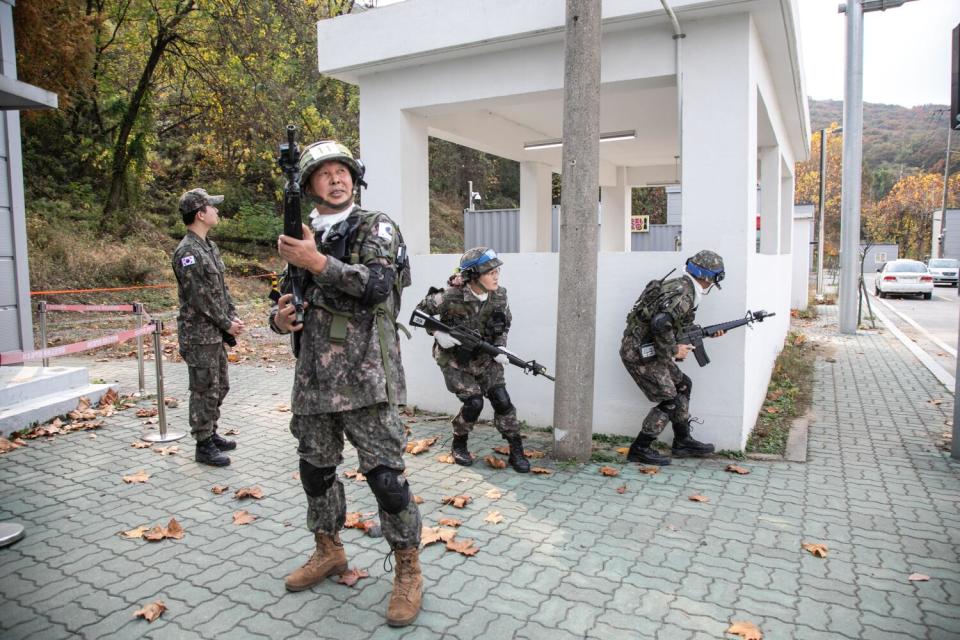 Members of the Senior Army participate in mock urban warfare during military training at the Infantry