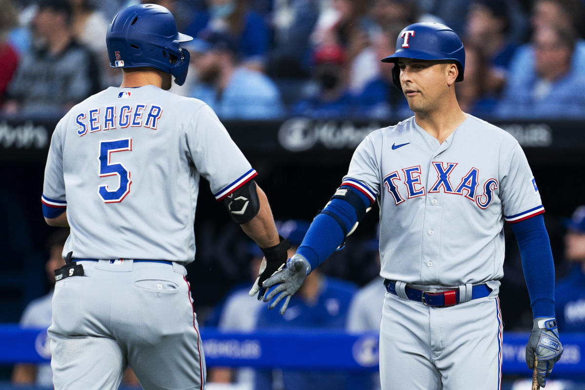 Texas Rangers' Corey Seager, left, greets Marcus Semien after his